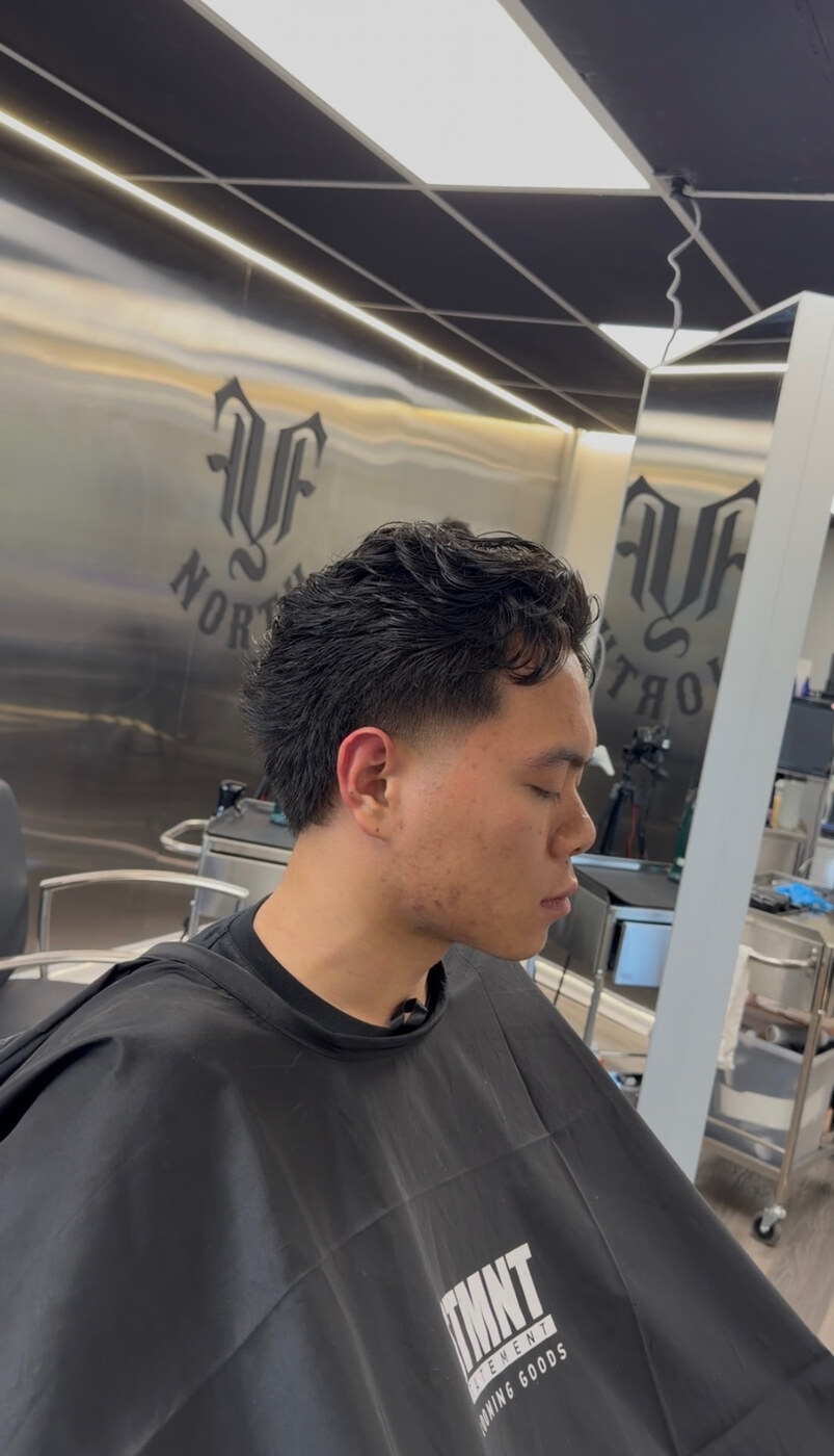 Low fade with textured top in the studio at fyf North by AJ Thong