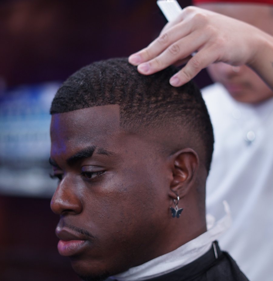 Barber detailing a textured crop on stage at a fyf North event
