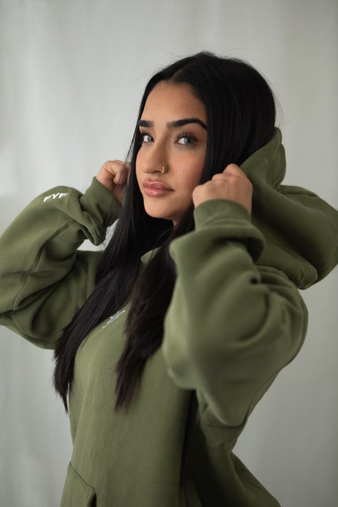 Client with long dark hair and a green hoodie at fyf North