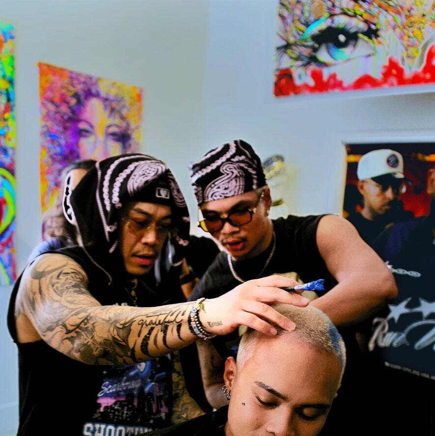 Artists colouring a client's buzz cut at a fyf North event
