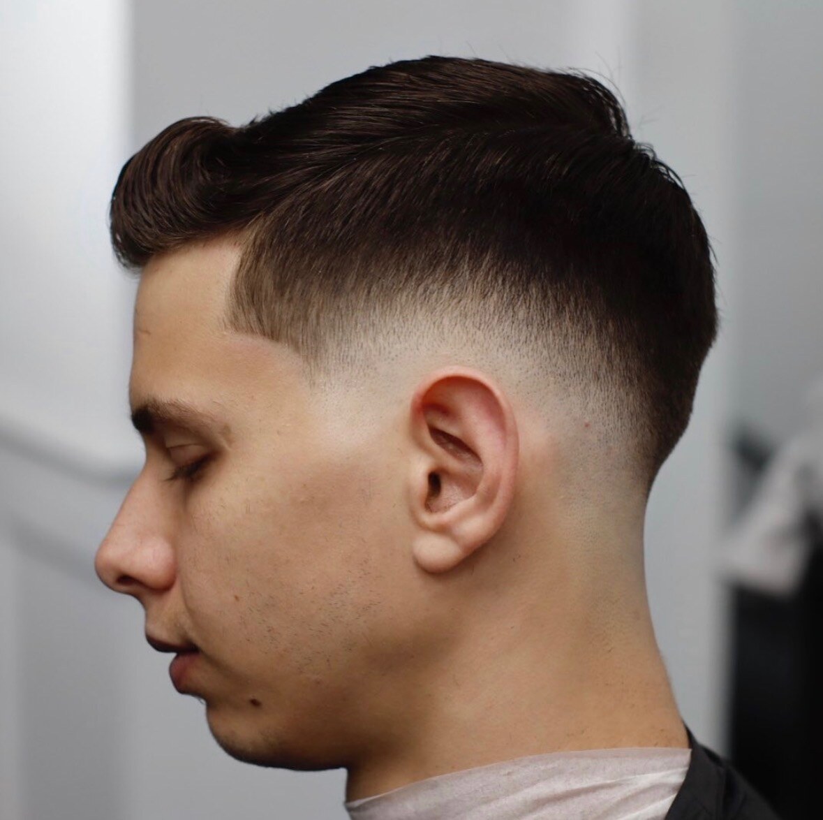 Classic low skin fade with side part by Eiron Pascua