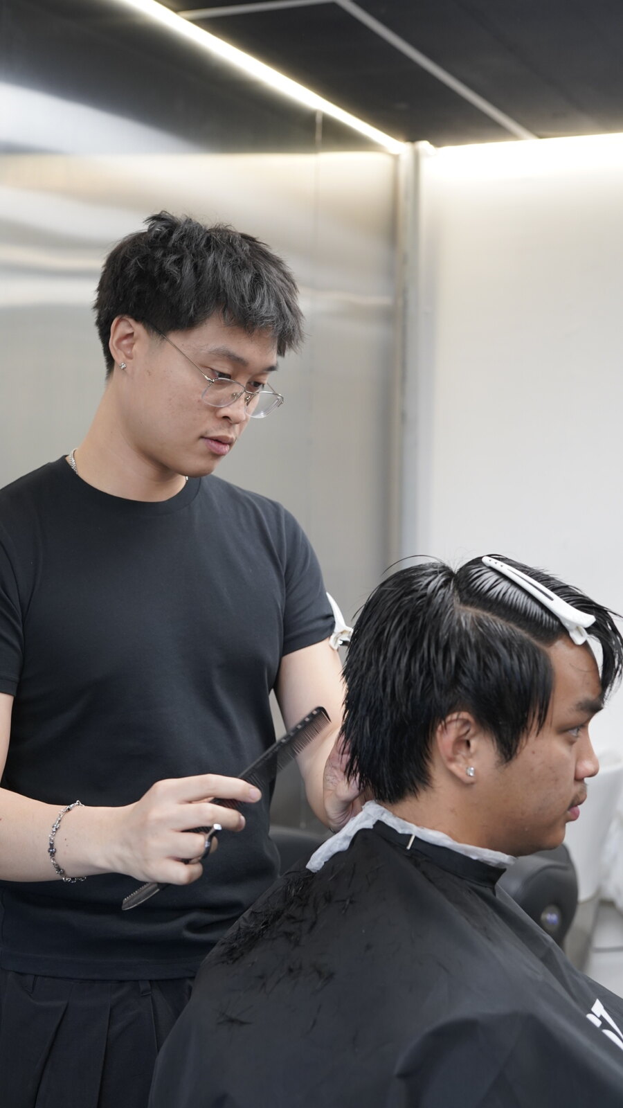 Stylist cutting a client's hair at fyf North