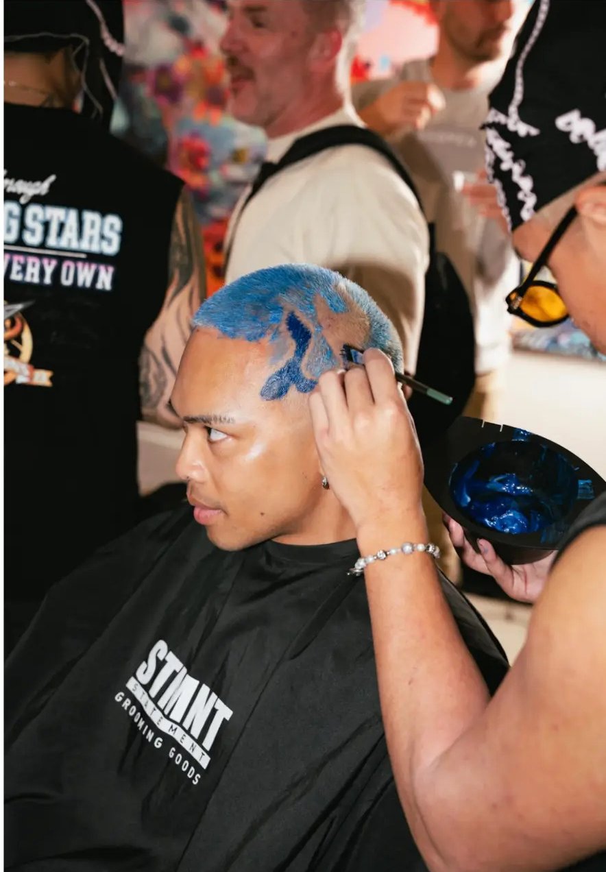 Blue colour design painted into a buzz cut at a fyf North event